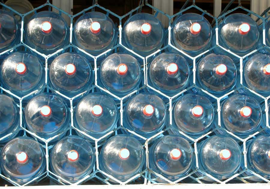 Large jugs of drinking water stacked in a rack